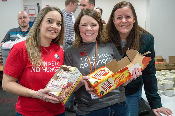 KFC and Henny Penny Employees pack 1,500 bags of food for Local Kids