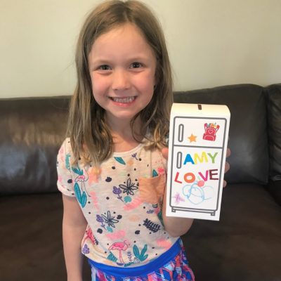 girl with decorated piggy bank