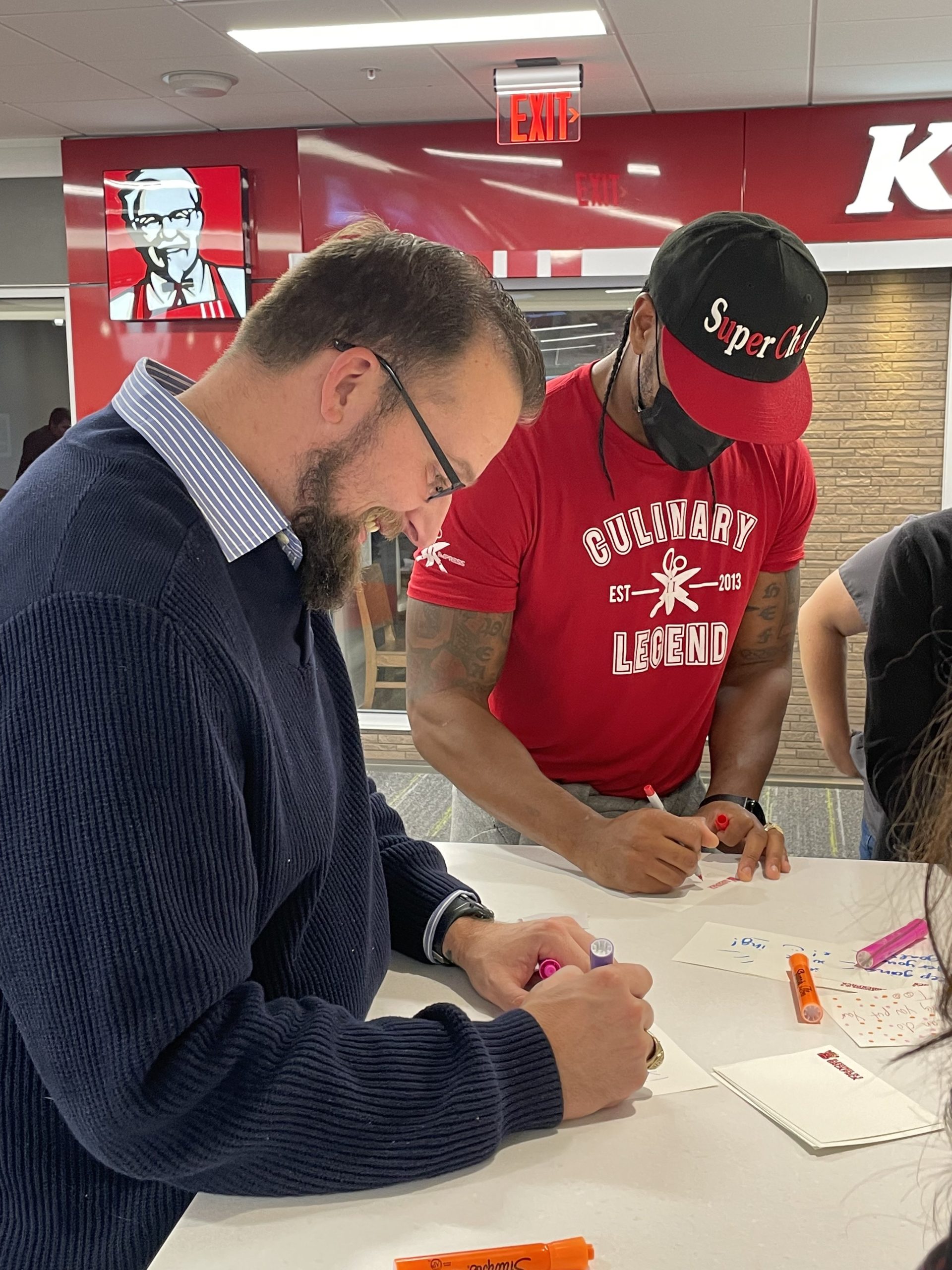 Darnell and Employees writing Notecards