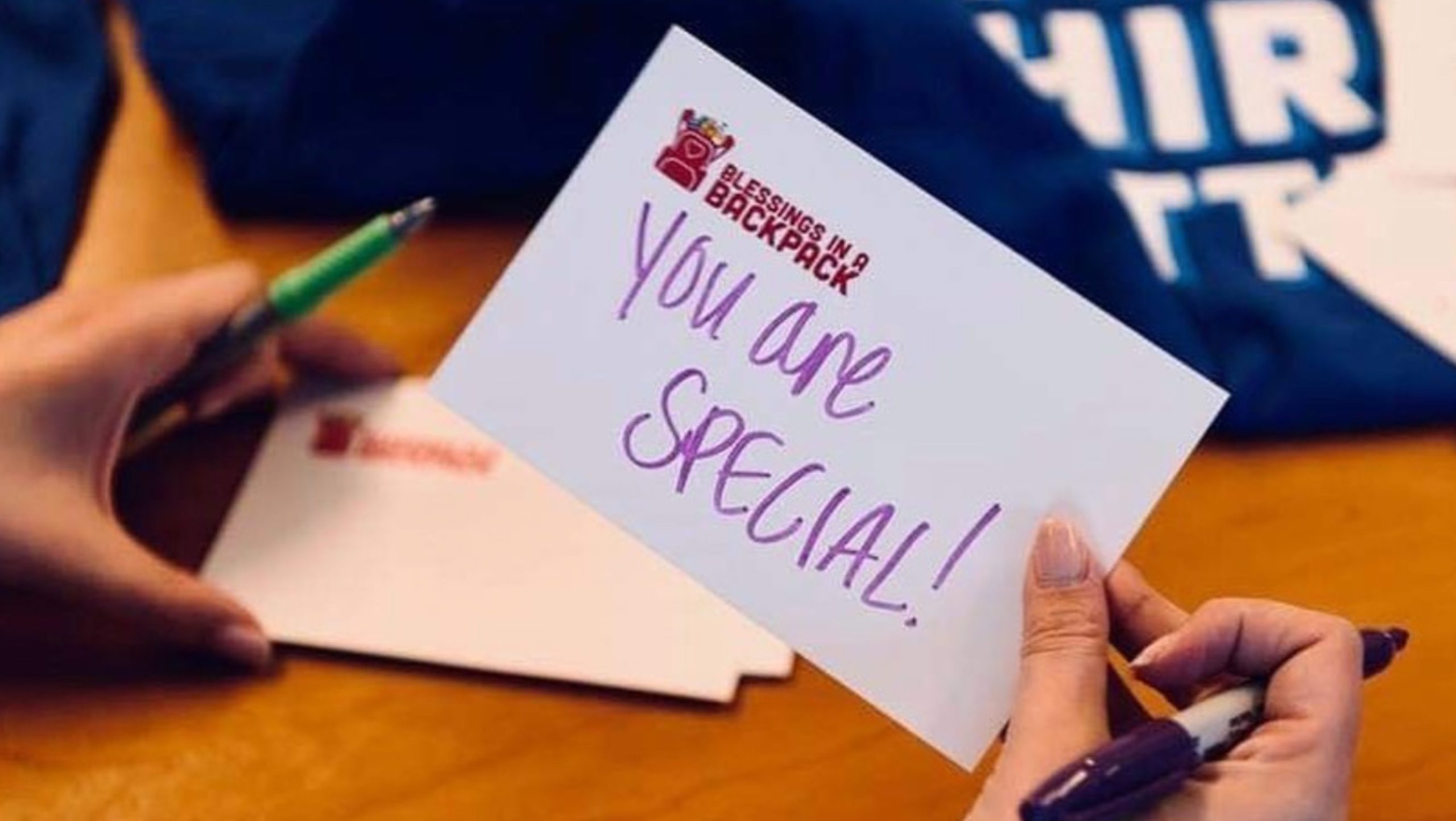 Woman writing a note card for a child